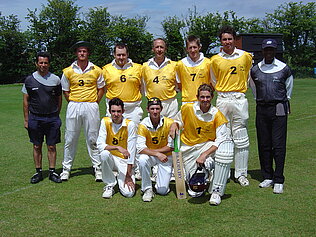 A cricket team dressed in yellow.