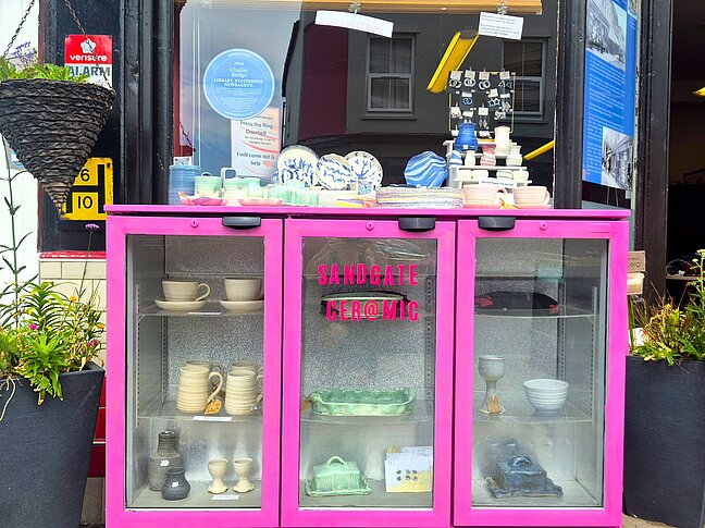 Sandgate Ceramic pink cabinet with mugs, egg cups, butterdishes for sale at 98 Sandgate high Street.