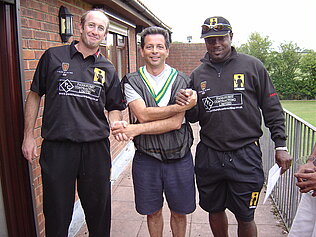 Three men shaking hands.