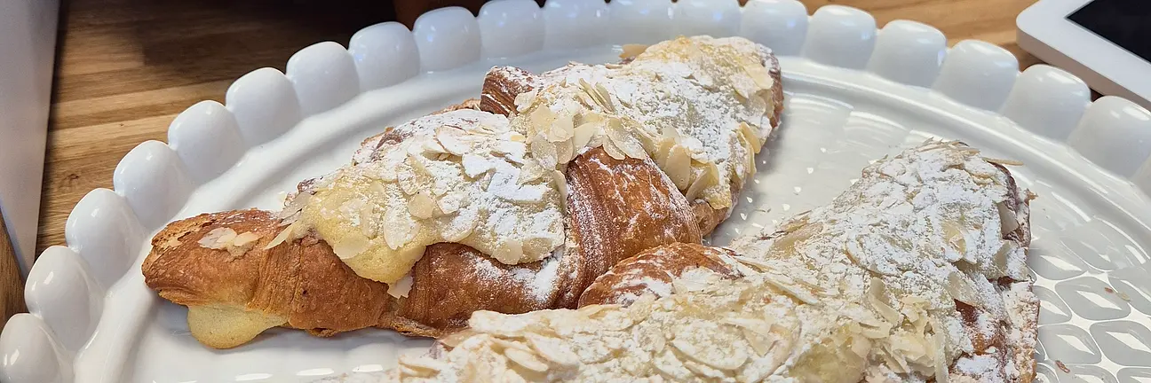 Two almond croissants on a plate