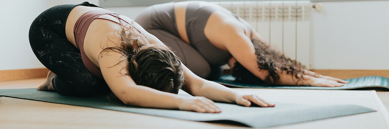 Two women doing pilates or yoga