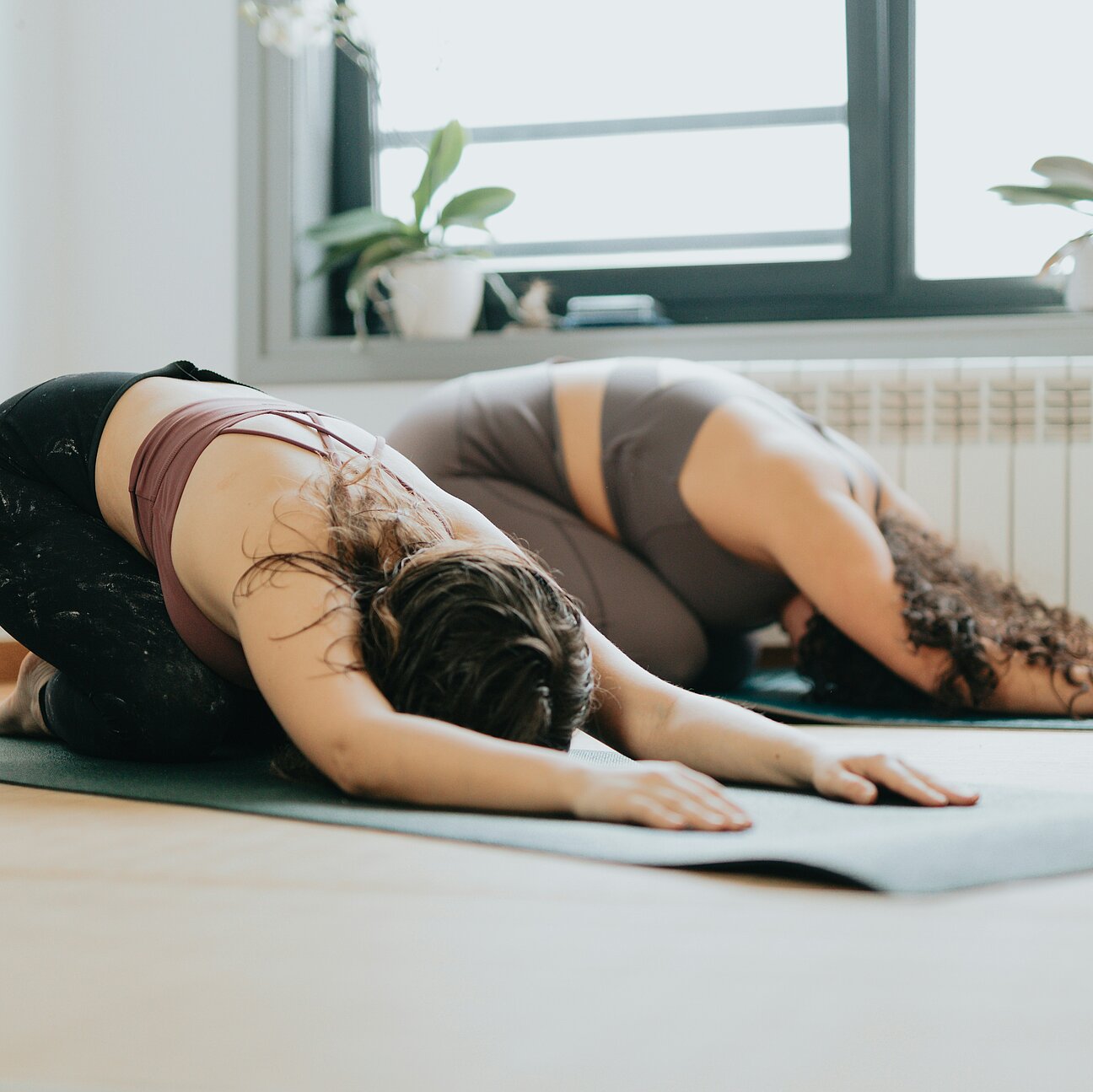 Two women doing pilates or yoga